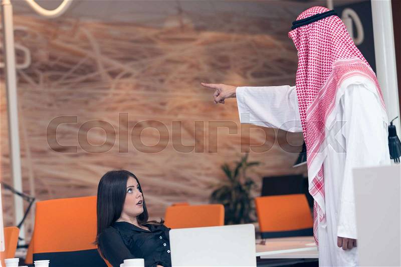 Woman office worker gets fired by arab businessman, stock photo