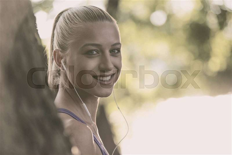 Breathing deep during jogging in the forest, stock photo