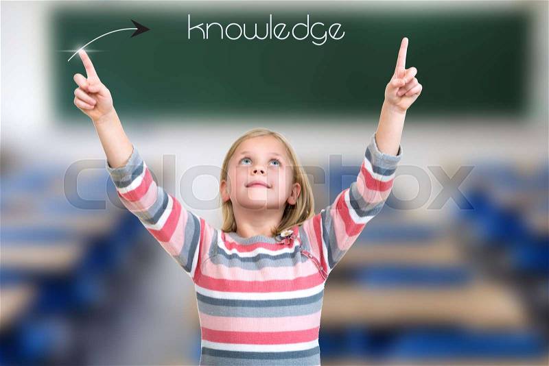 Little girl pointing on knowledge sign with hand, stock photo