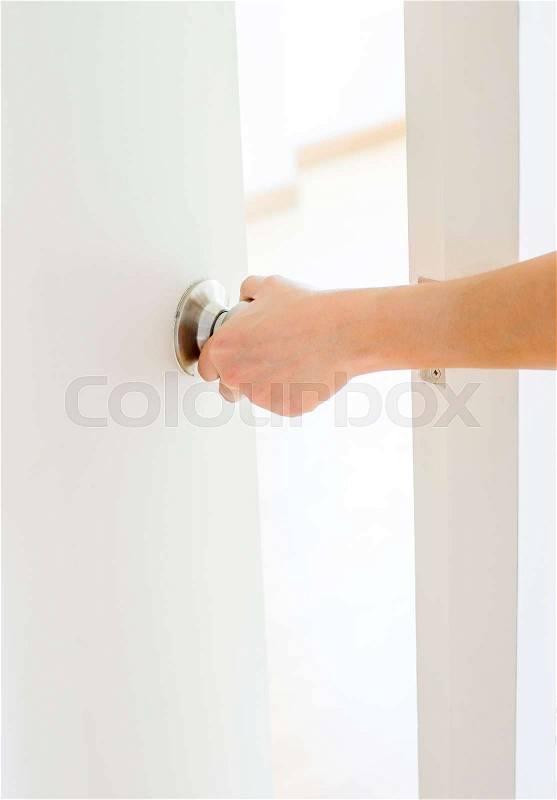 Hand opening door knob,white door, stock photo
