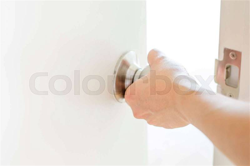 Hand opening door knob,white door, stock photo