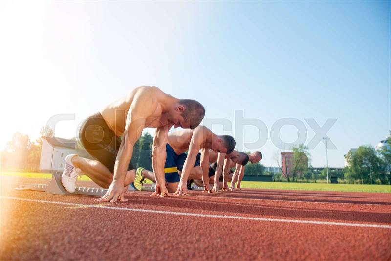 Male athletics runners on starting line without shirts. long-distance runner, dynamic image, closeup of photo, stock photo
