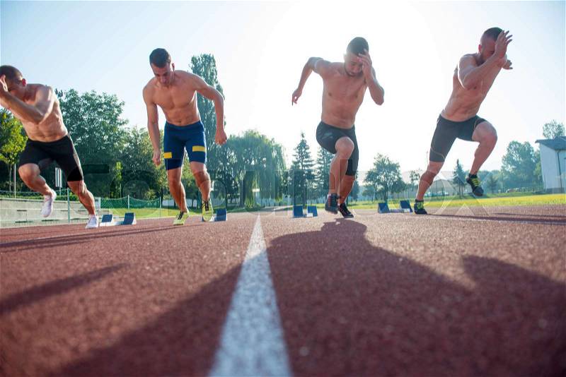Male athletics runners on starting line without shirts. long-distance runner, dynamic image, closeup of photo, stock photo