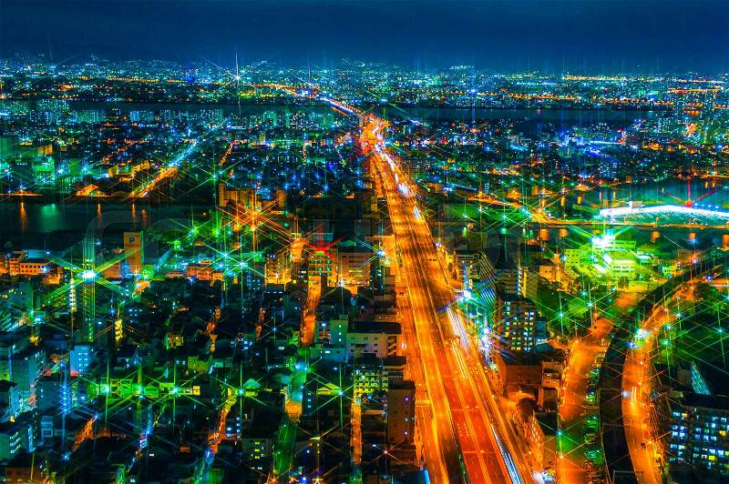 The image of the night city from the height of a bird\'s flight.A view of the night Osaka.Mnogo houses in iluminatsii.Dark time of the day, stock photo