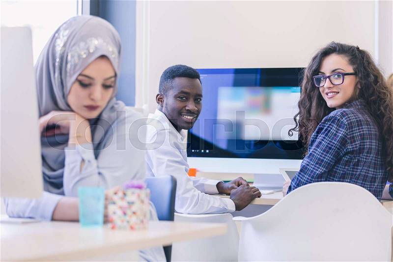 Ethnic business people, entrepreneurs working together using a computer, stock photo