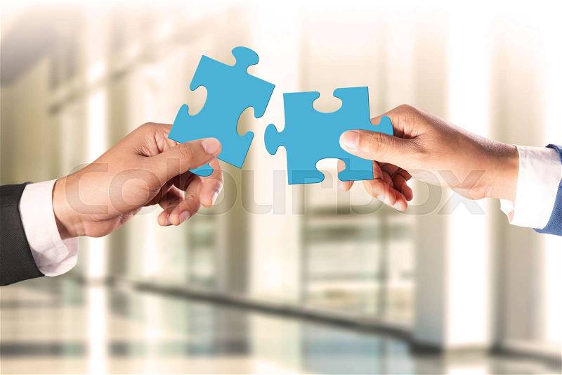 Business teamwork concept, businessman holding jigsaw puzzle concept, stock photo