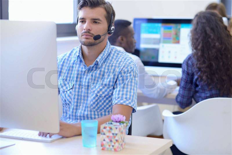Startup business, software developer working on desktop computer at modern office, stock photo
