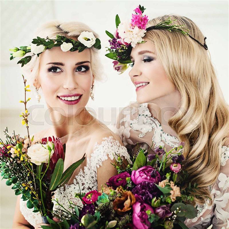 Flowers Style Portrait of Beautiful Women. Perfect Bride. Blonde Women with Flower Arrangement, Flower Wreath, Wedding Hairdo and Make up, stock photo