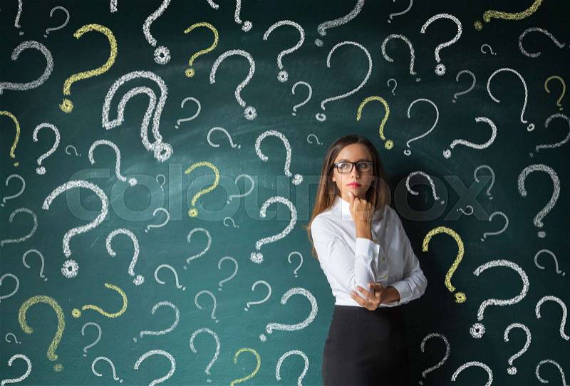Businesswoman and question mark drawn in chalk on blackboard, stock photo