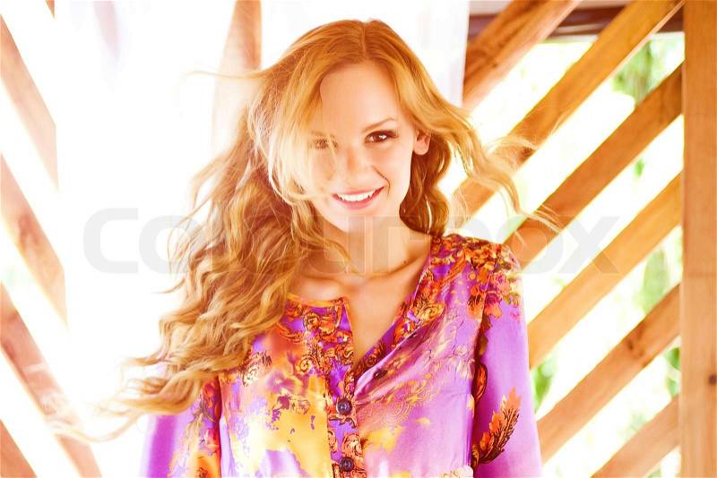 Beautiful young women in a violet tunic, stock photo