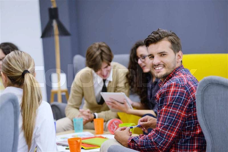 Group of young business people, Startup entrepreneurs working on their venture in coworking space, stock photo