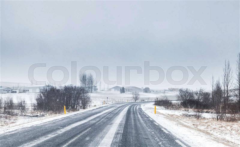Snowy Icelandic road perspective, empty rural landscape, stock photo