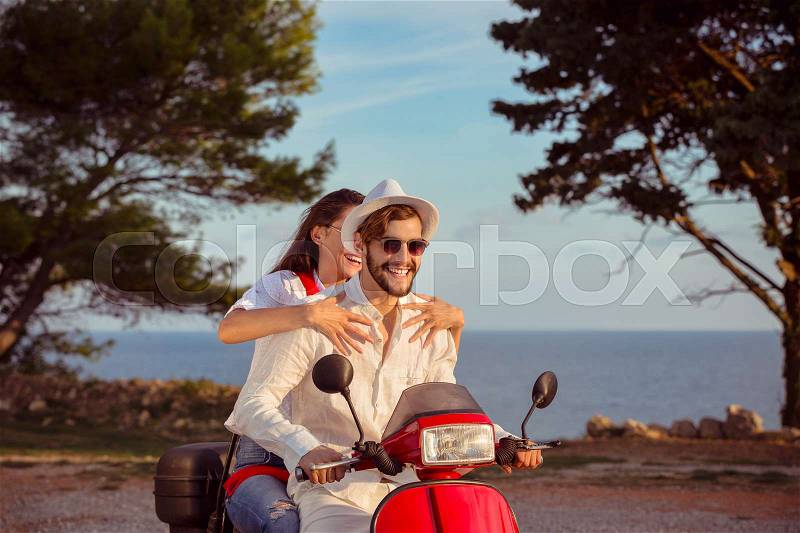 Couple in love riding a motorbike , Handsome guy and young sexy woman travel . Young riders enjoying themselves on trip. Adventure and vacations concept, stock photo