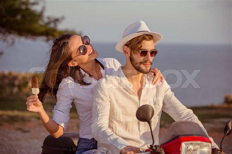 Couple in love riding a motorbike , Handsome guy and young sexy woman travel . Young riders enjoying themselves on trip. Adventure and vacations concept, stock photo