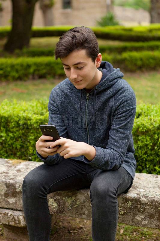 Cool teenager with fifty years old and a mobile on the street, stock photo