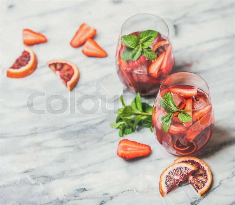 Fruit refreshing Sangria cocktails with ice and fresh mint, stock photo