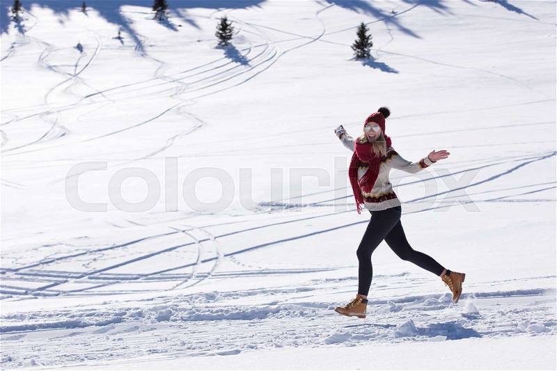 Running woman runner in winter mountains on snow, stock photo
