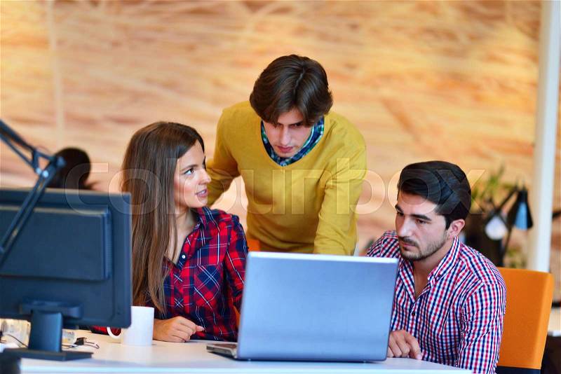 Teamwork. Three young architects working on a project, stock photo