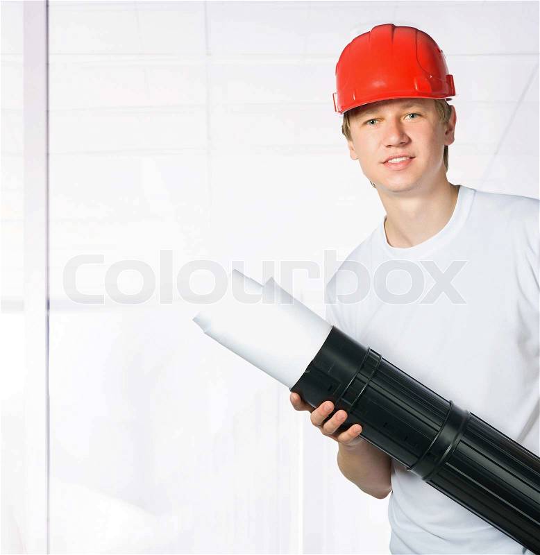 Portrait of a builder on a office build background, stock photo