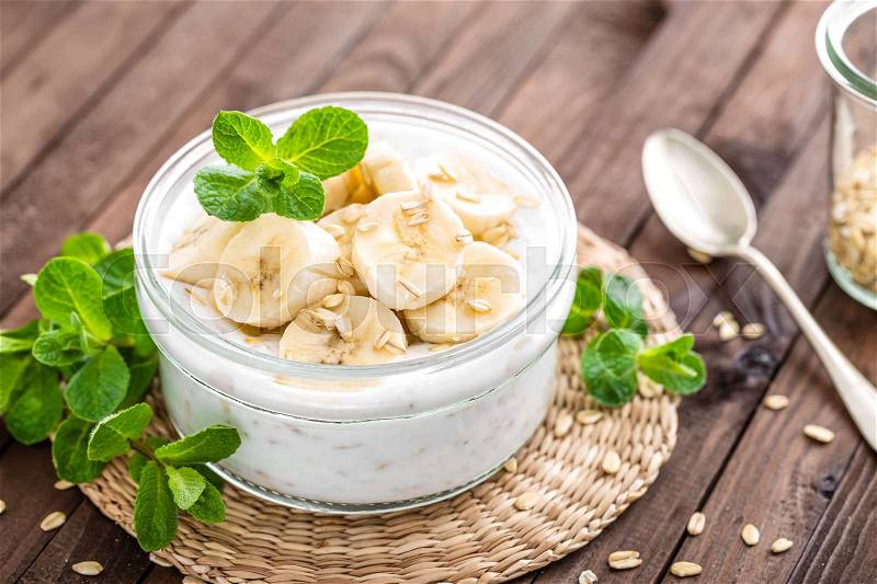 Fresh banana yogurt with oats, delicious dessert for healthy breakfast, stock photo