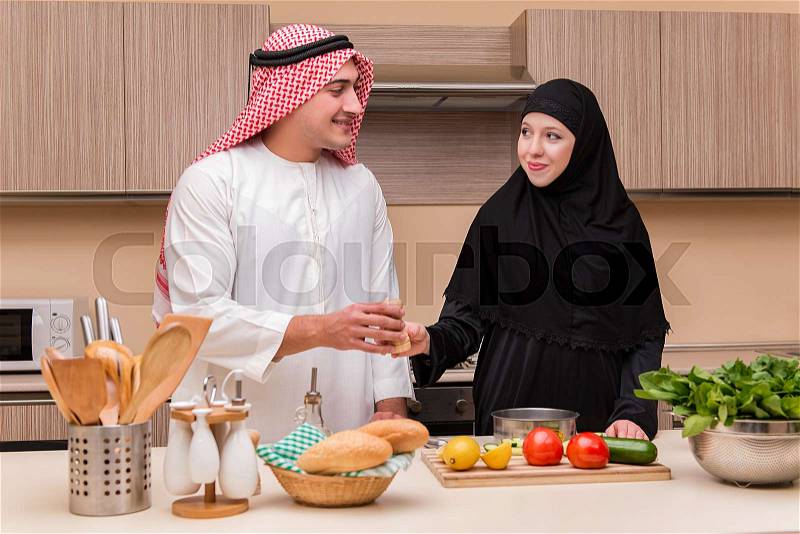 Young arab family in the kitchen, stock photo