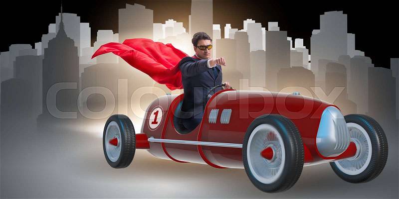 Superhero businessman driving vintage roadster, stock photo