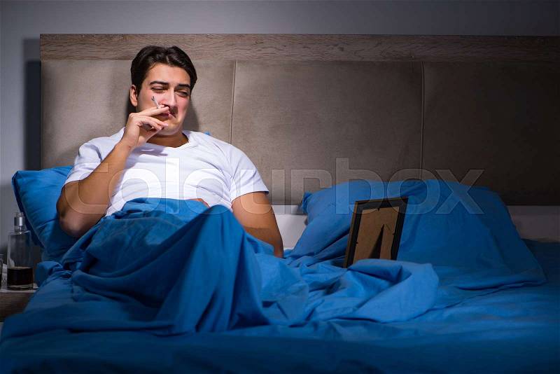 Desperate man divorced in bed, stock photo
