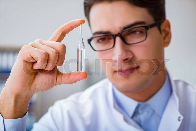 Doctor holding medicines in the lab, stock photo