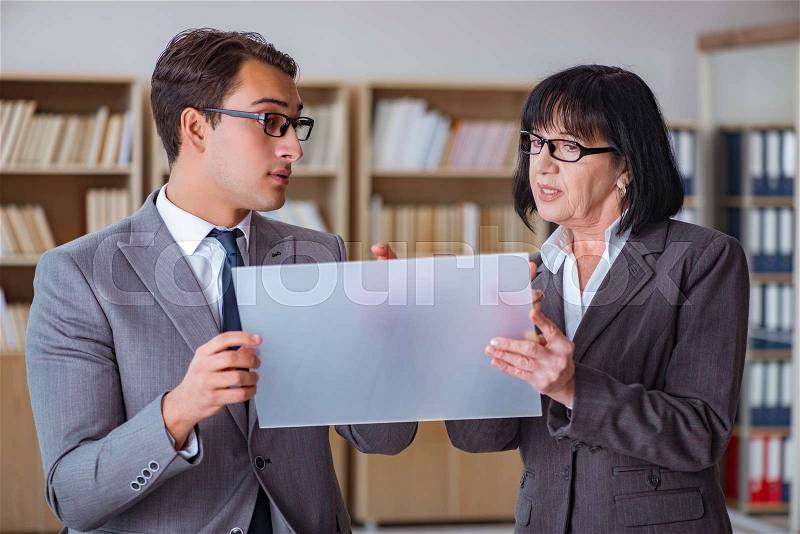 Businesspeople discussing business results on tablet computer, stock photo