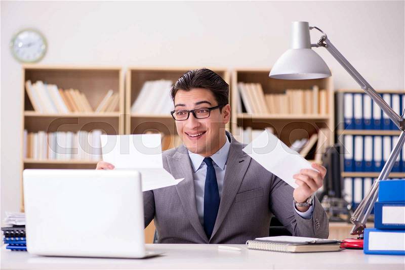 Businessman receiving letter in the office, stock photo