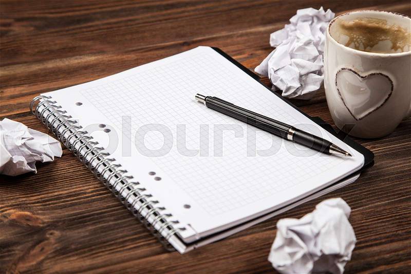 Creative block concept - blank notepad and crumpled paper, stock photo