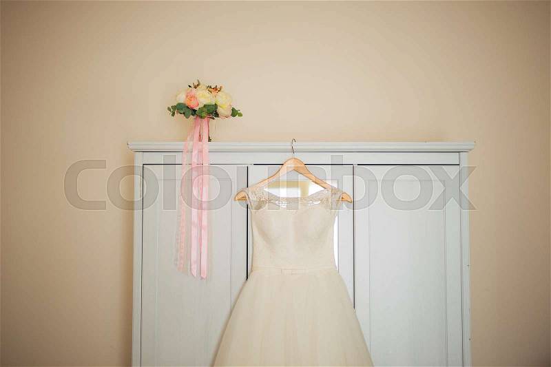 The bride's dress on a hanger in the room in Montenegro, stock photo
