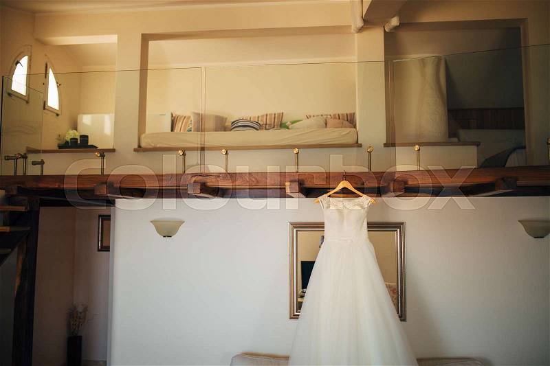 The bride's dress on a hanger in the room in Montenegro, stock photo
