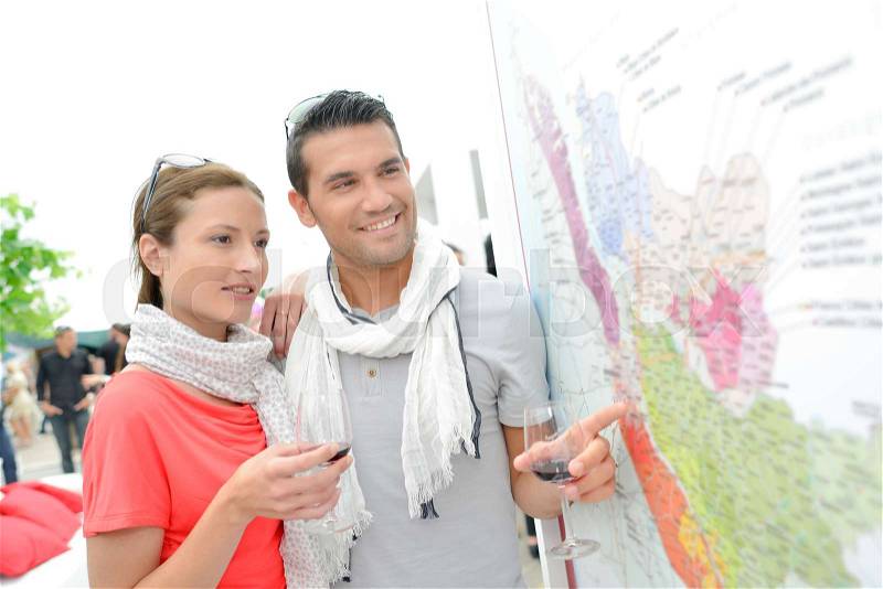 Young couple checking a map of wine-growing regions, stock photo