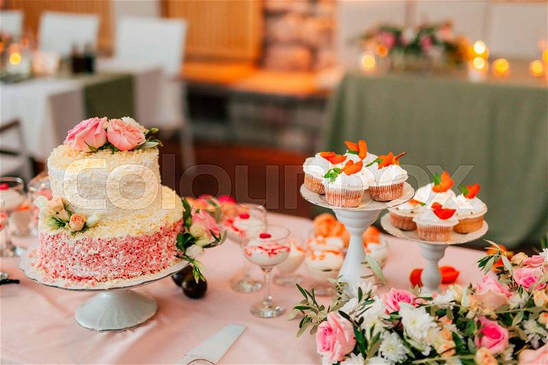 White wedding cake with flowers and blueberries, stock photo