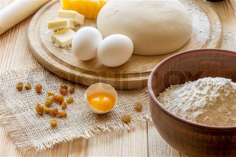 Ingredients for cooking dough, sweet baking. Bowl of flour, butter and eggs on a cutting board, stock photo