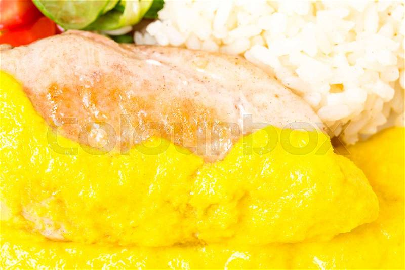 Roasted chicken fillet with rice and fresh vegetables as a garnish. Served with delicious saffron mousse. Macro. Photo can be used as a whole background, stock photo