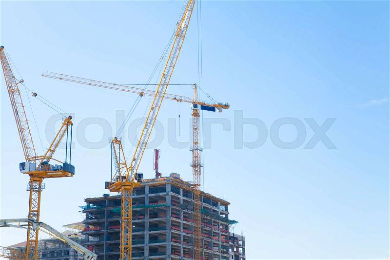 Cranes on a construction site, stock photo