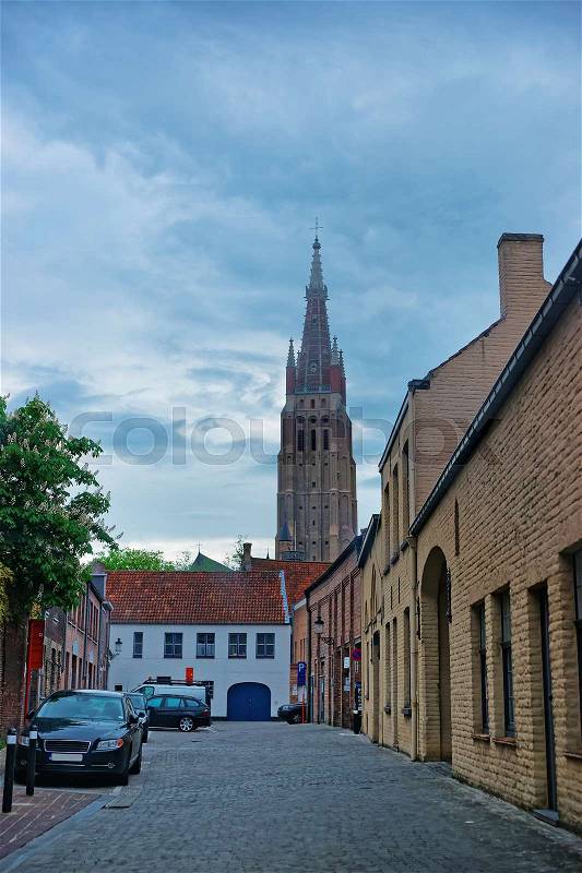 Street view on Church of Our Lady in the medieval old city in Brugge, Belgium, stock photo