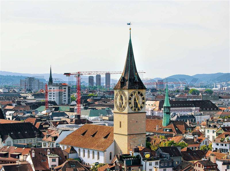 Spires of Saint Peter Church and Augustinian Church and rooftops of the city center of Zurich, Switzerland, stock photo