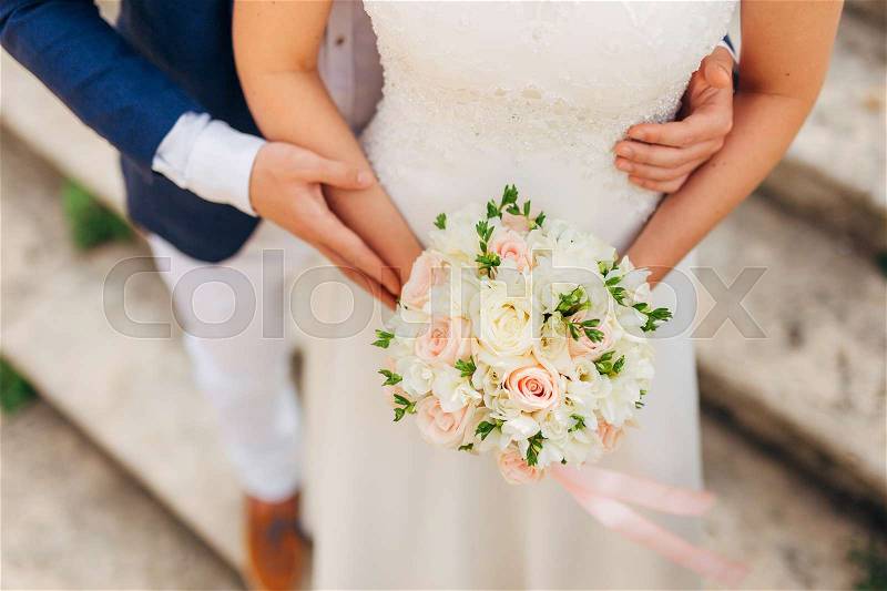 Wedding bouquet in hands of the bride. Wedding in Montenegro, stock photo