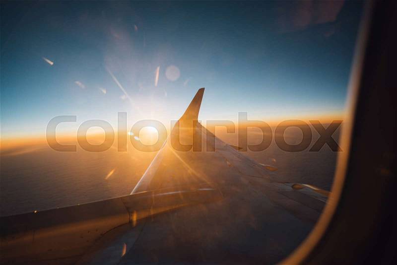 Beautiful view from plane window to the clouds and plane wing, stock photo
