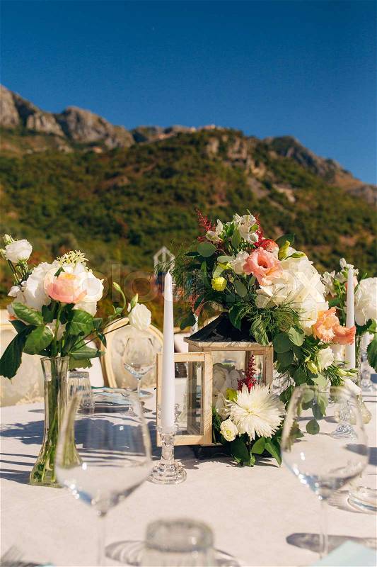 Flower compositions on the wedding table in rustic style. Wedding decorations with their own hands. Wedding in Montenegro, stock photo