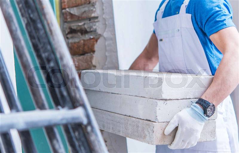 Construction Worker Moving Concrete Materials For House Interior Remodeling, stock photo