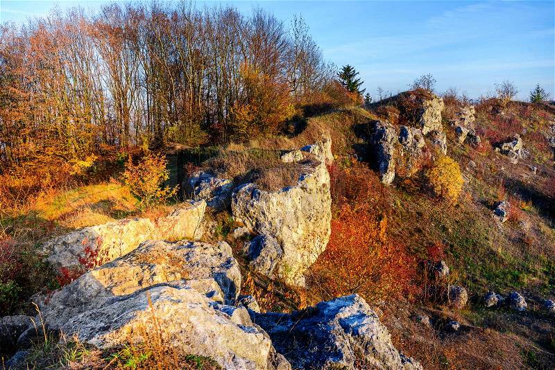 Rocky landscape during autumn. Beautiful landscape with stone, forest and fog. Sunset in czech national park. Misty evening autumn landscape. Landscape with rock hills, stock photo