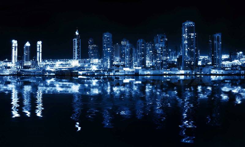 City at night, panoramic scene of downtown reflected in water, Dubai, stock photo