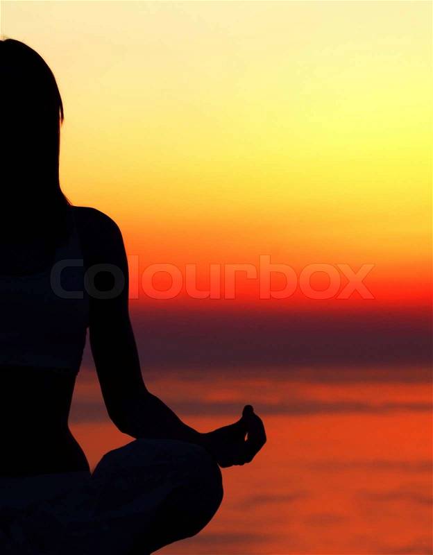 Healthy woman doing yoga outdoor, sunset over sea, body care & meditation concept, stock photo