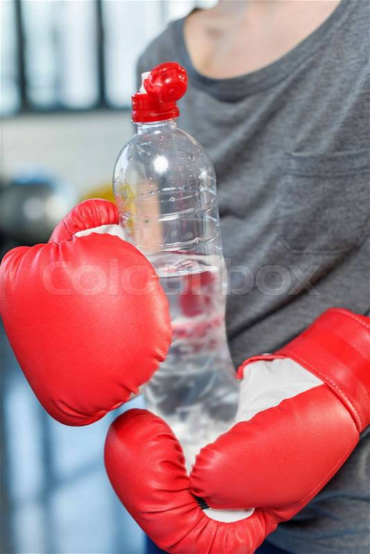 Preteen child in boxing gloves with sport bottle. gym class kids concept, stock photo