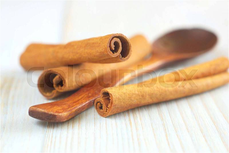 Cinnamon sticks with wooden spoon old style retro background. Selective focus. , stock photo
