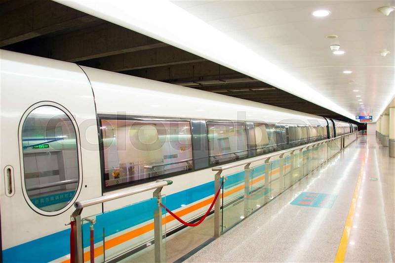 Bright modern train at an empty train staition , stock photo